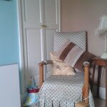 Small infrared heating panel on feet in a bedroom